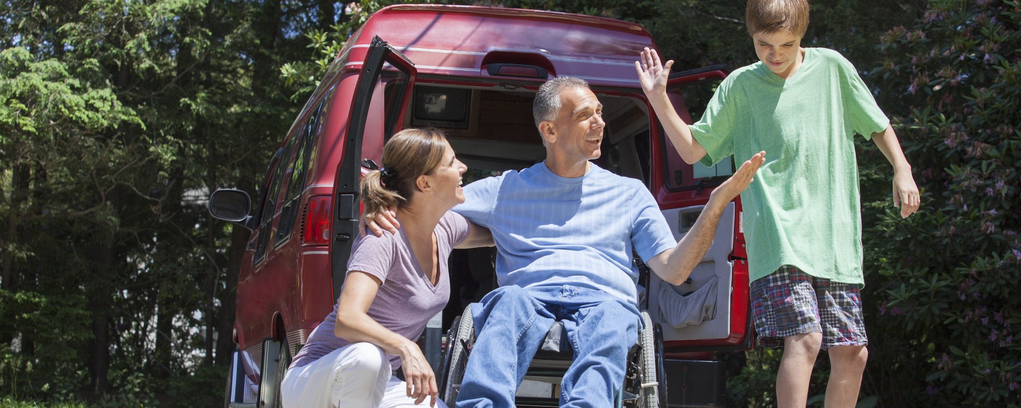 scican - man in wheel chair with family